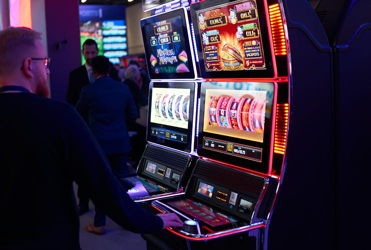 A man playing on a slot machine