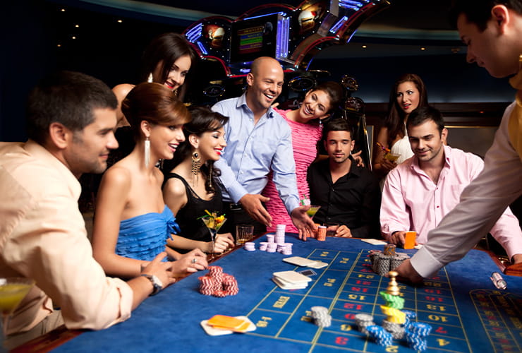 A large group of people playing at the roulette table
