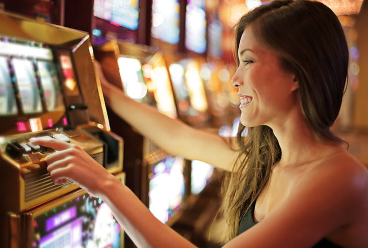 Woman playing on a slot machine