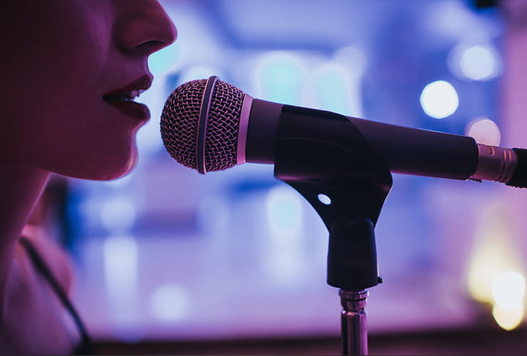 A female singer performing close to the microphone