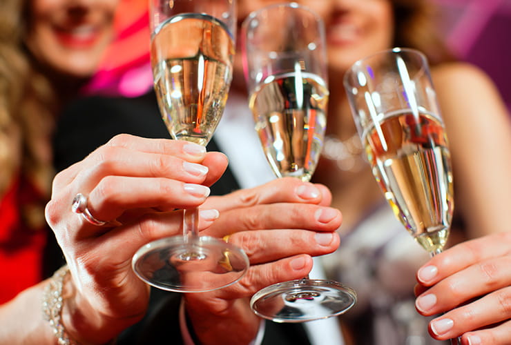 Three champagne glasses filled with champagne