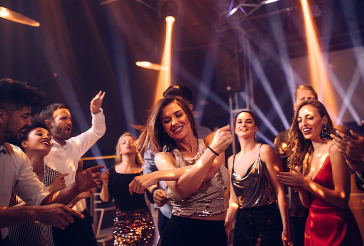 A group of friends having a great time and dancing in the club