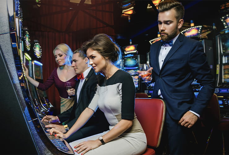 A group of friends playing at the slot machines
